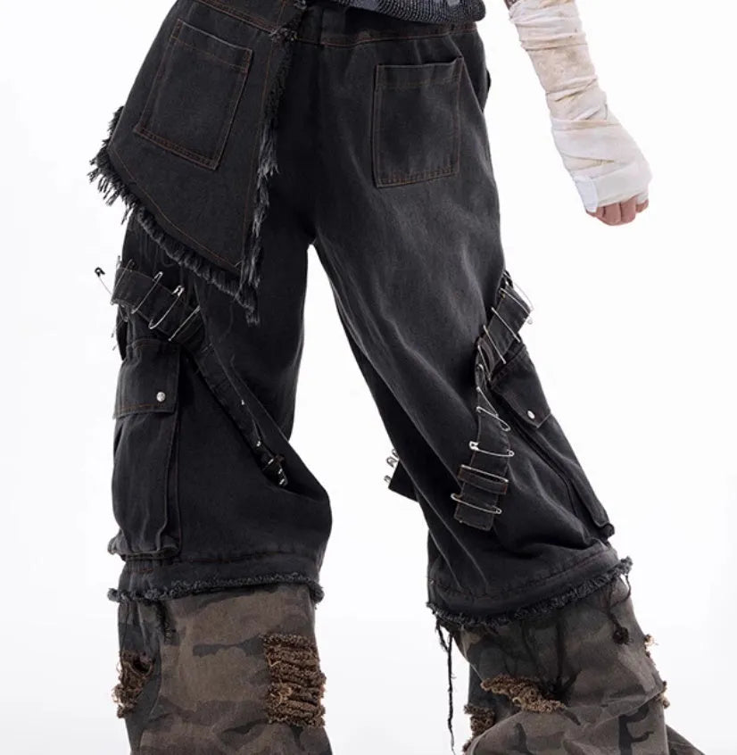 Men's grey jeans with camouflage pattern splicing and pin ribbon details on the legs.