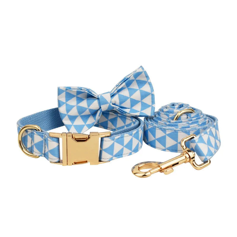 Blue triangular ring on a cloth dog collar and lead set with matching bow and vest, shown in a four-piece pet accessory package.