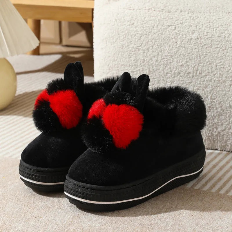 A pair of grey high heel winter slippers with a thick sole and plush upper, shown on a white background.