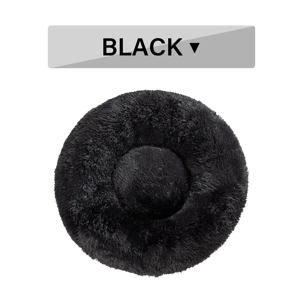 Fluffy donut-shaped dog bed in long plush fabric, shown in a light grey colour with a raised bolster edge.