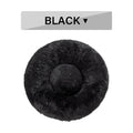 Fluffy donut-shaped dog bed in long plush fabric, shown in a light grey colour with a raised bolster edge.