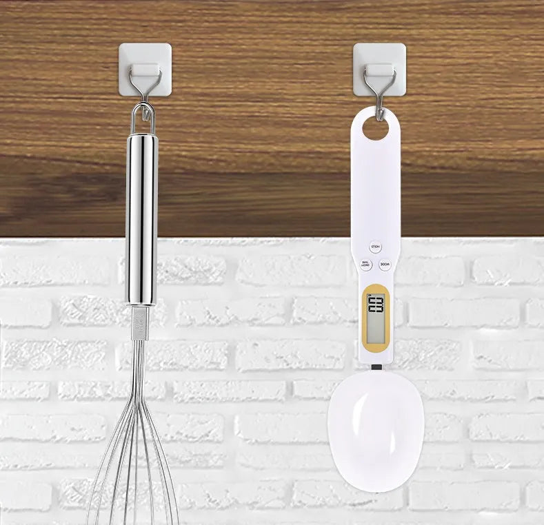 Black electronic measuring spoon scale showing digital display with 0.1g precision for kitchen weighing