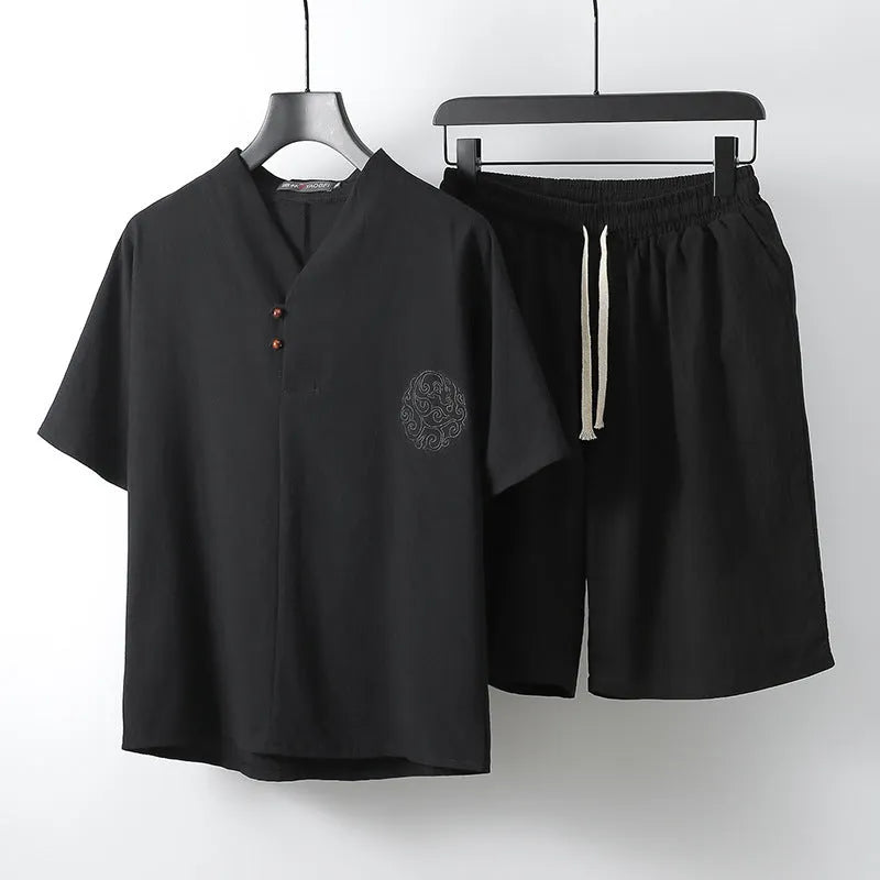 Man modelling a loose-fit cotton two-piece set with short sleeve top and shorts in a light colour.