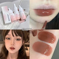 Mirror Lip Lacquer moisturising lip gloss tube in sheer shades on a plain background.