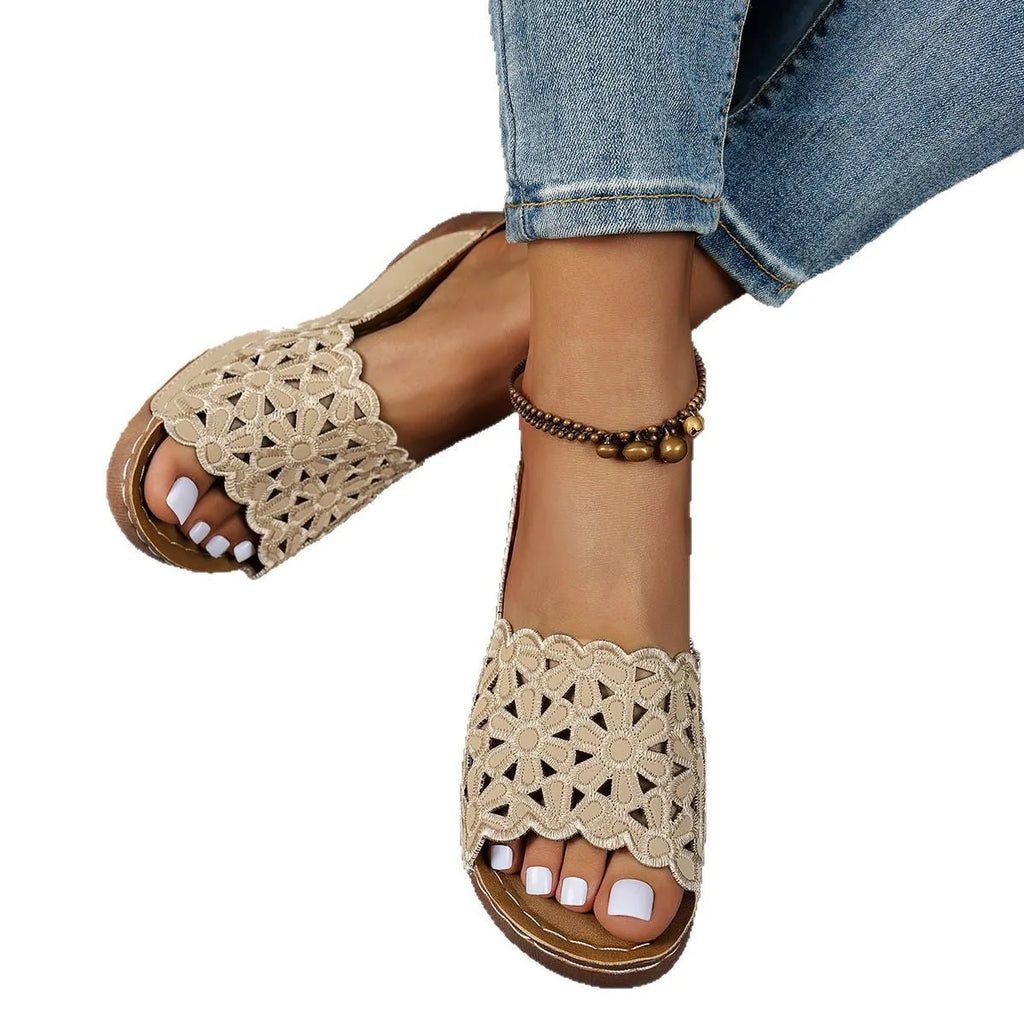 Women's black wedge beach slippers with flower cutout design and open fish mouth toe.