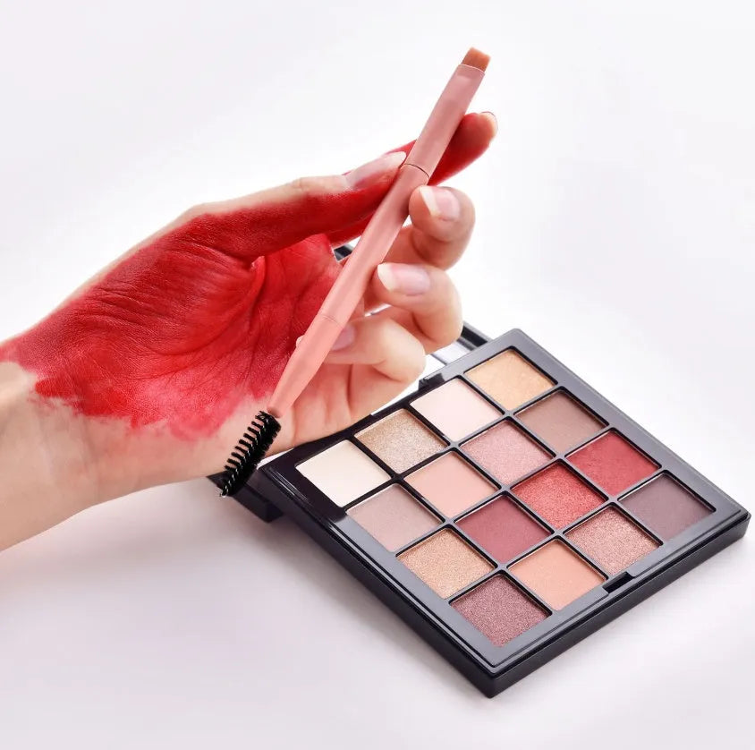 10 cosmetic brushes with wooden handles and nylon bristles arranged with makeup products