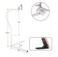 Black bedside mobile phone bracket with universal clamp mounted on a bed frame.