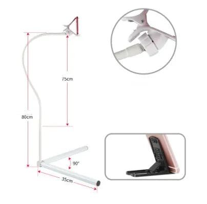 Black bedside mobile phone bracket with universal clamp mounted on a bed frame.