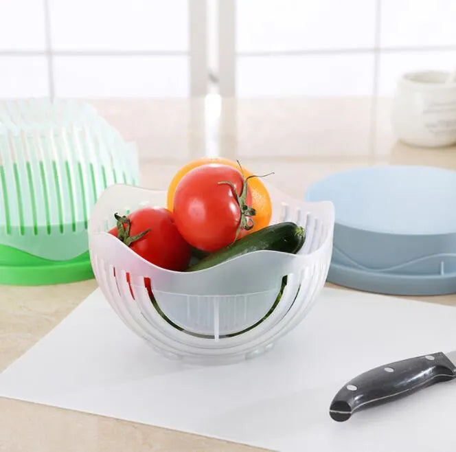 Blue BPA-free plastic salad cutter bowl with cutting grid lid on a white base with raised edges.