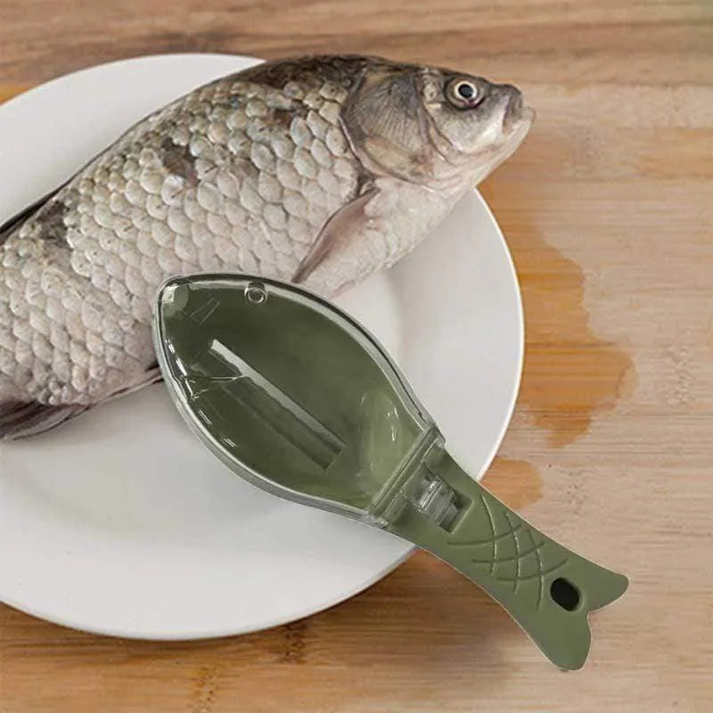 White fish-shaped kitchen scaler tool with a cover and hanging hole on handle