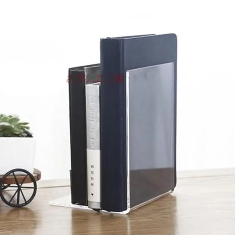 Clear transparent acrylic bookshelf holding a small number of books on a desk