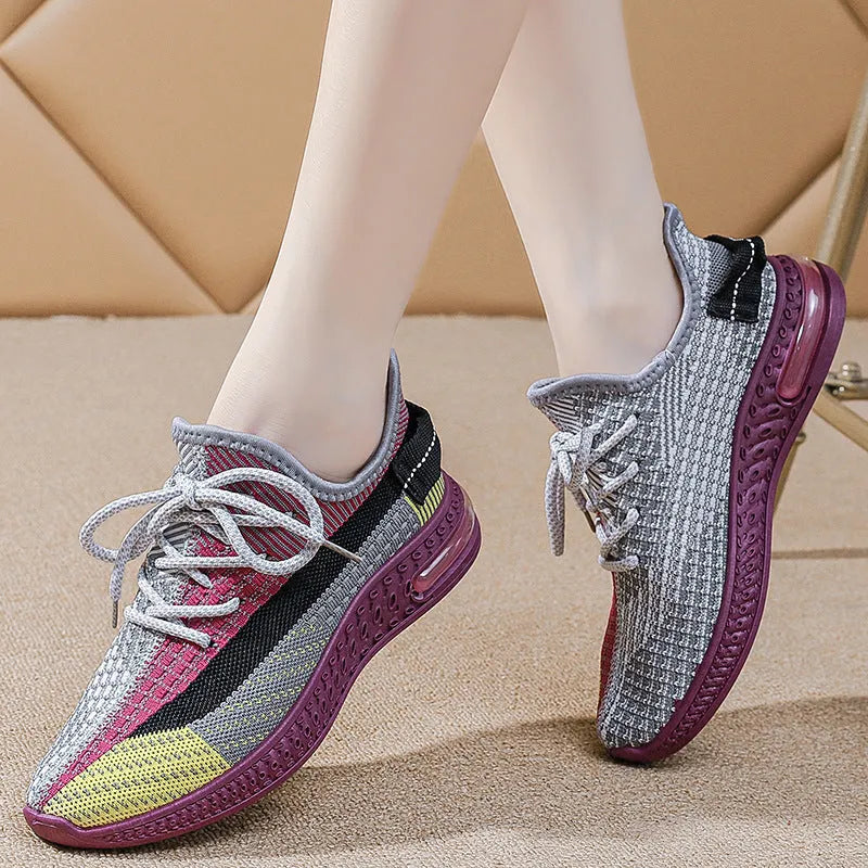 Women's low-top running shoes in purple, featuring a rounded toe and front lace-up design.