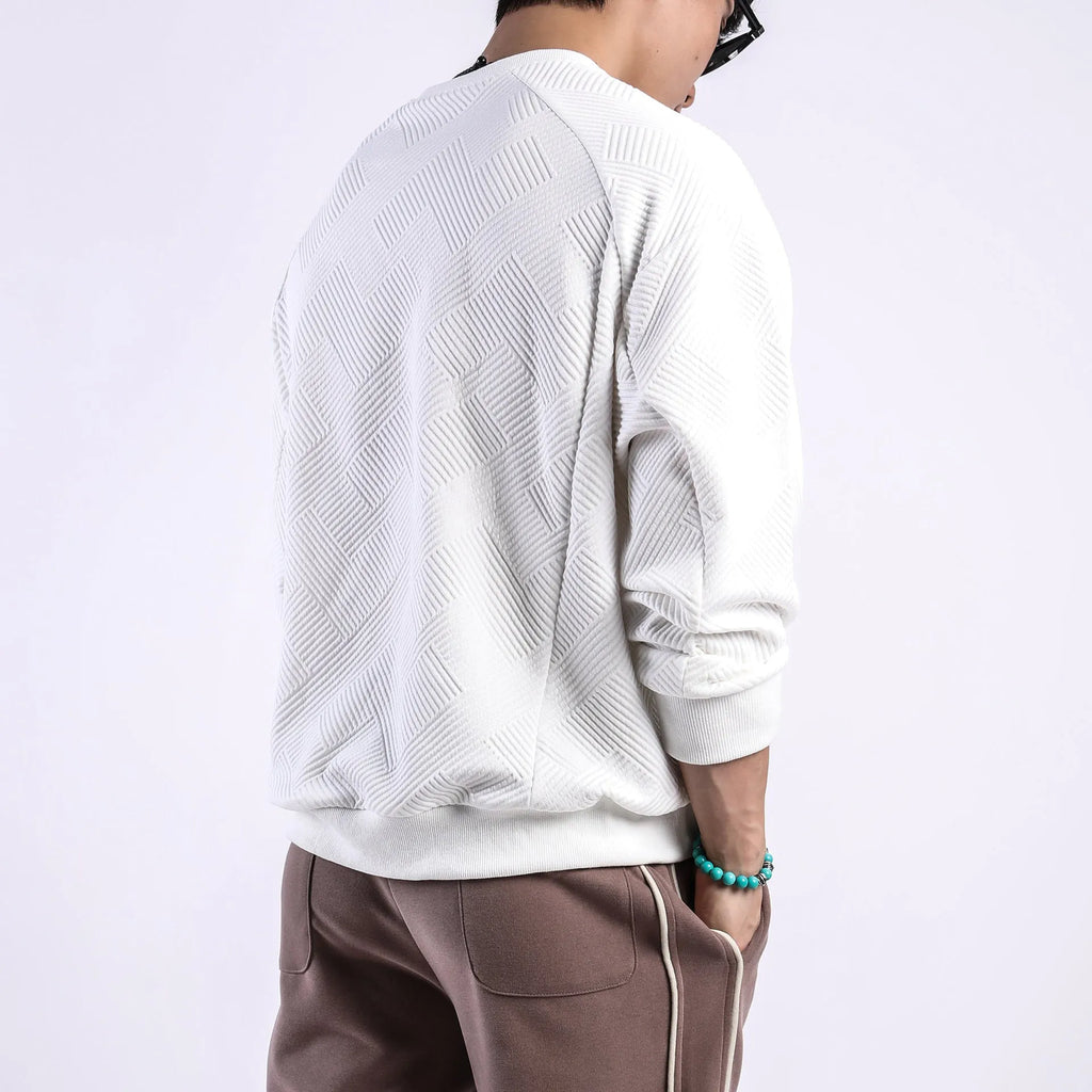Men's solid colour long-sleeved sweater in twill jacquard fabric, shown in a loose fit with a round neck.