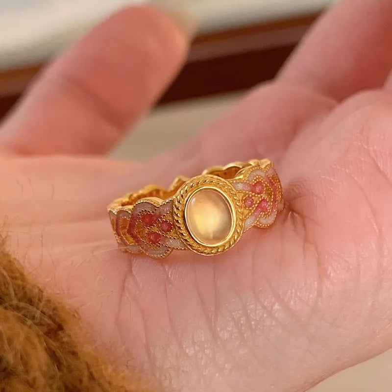 Pink crystal enamel ring with geometric design and adjustable open mouth on a copper base
