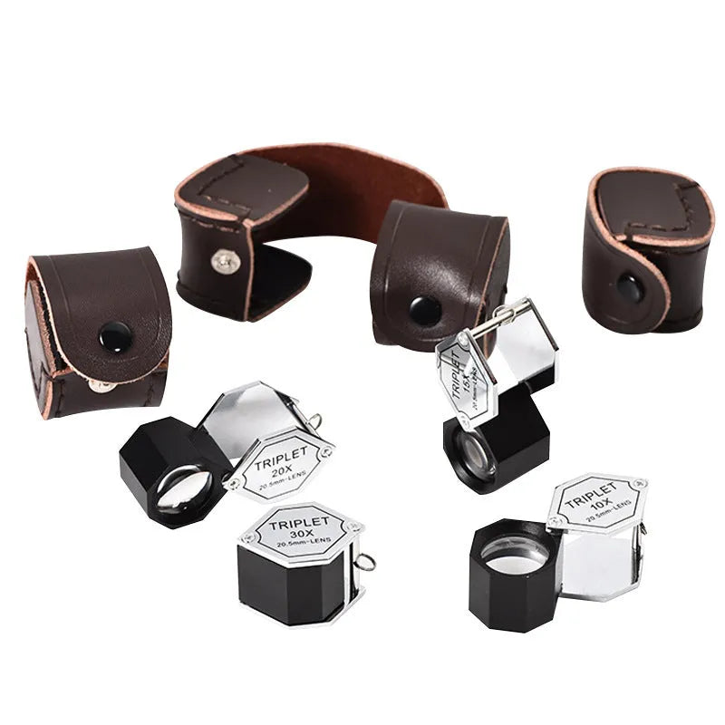 Handheld metal and optical glass magnifying loupe for jewellery and coin inspection.