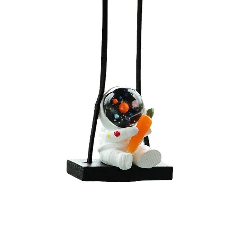 Resin cartoon astronaut car pendant hanging from a rear-view mirror.