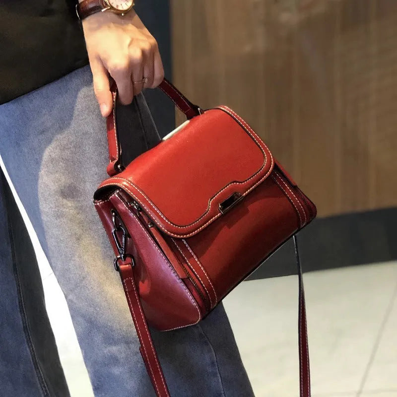 Women's brown genuine oil wax leather messenger bag with double shoulder straps and visible sewing lines