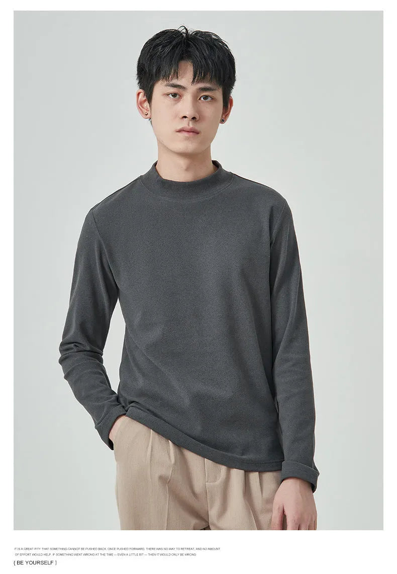 Man's brown long sleeve Dralon T-shirt with a half-high collar, laid flat.