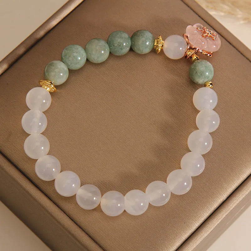 White agate jade bracelet with pink floral detailing and adjustable fastening