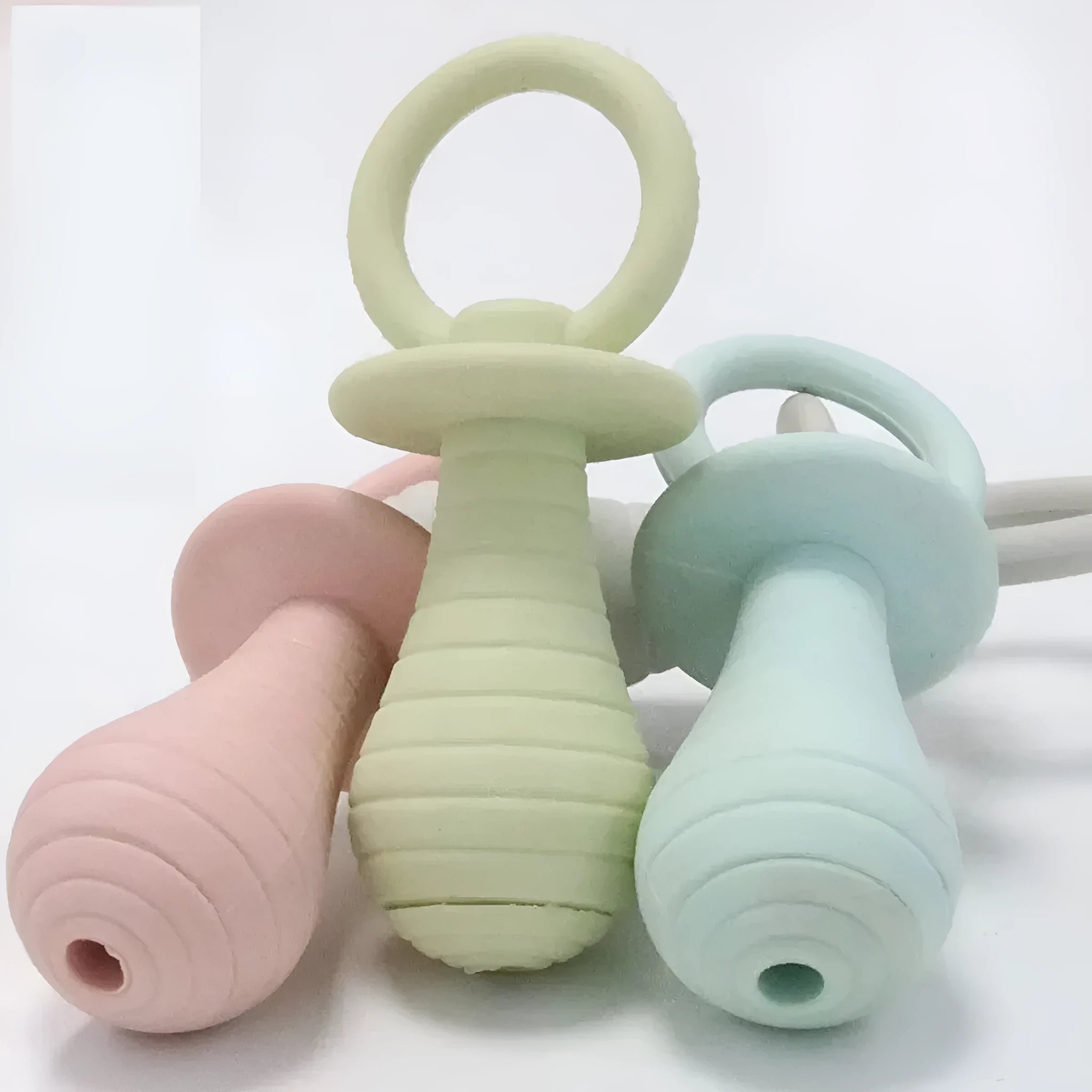 A green TPR rubber pet pacifier chew toy with a squeaker for puppies and kittens.