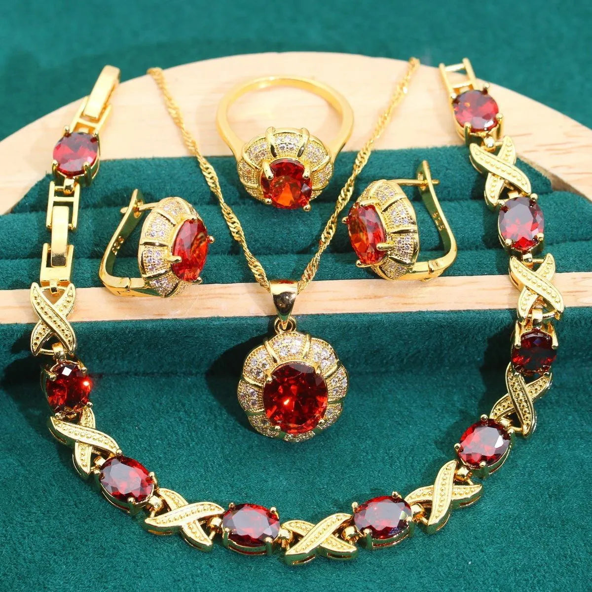 18k gold plated four-piece jewellery set with synthetic cubic zirconia stones in Raytheon cut, showing necklace, earrings, ring, and bracelet