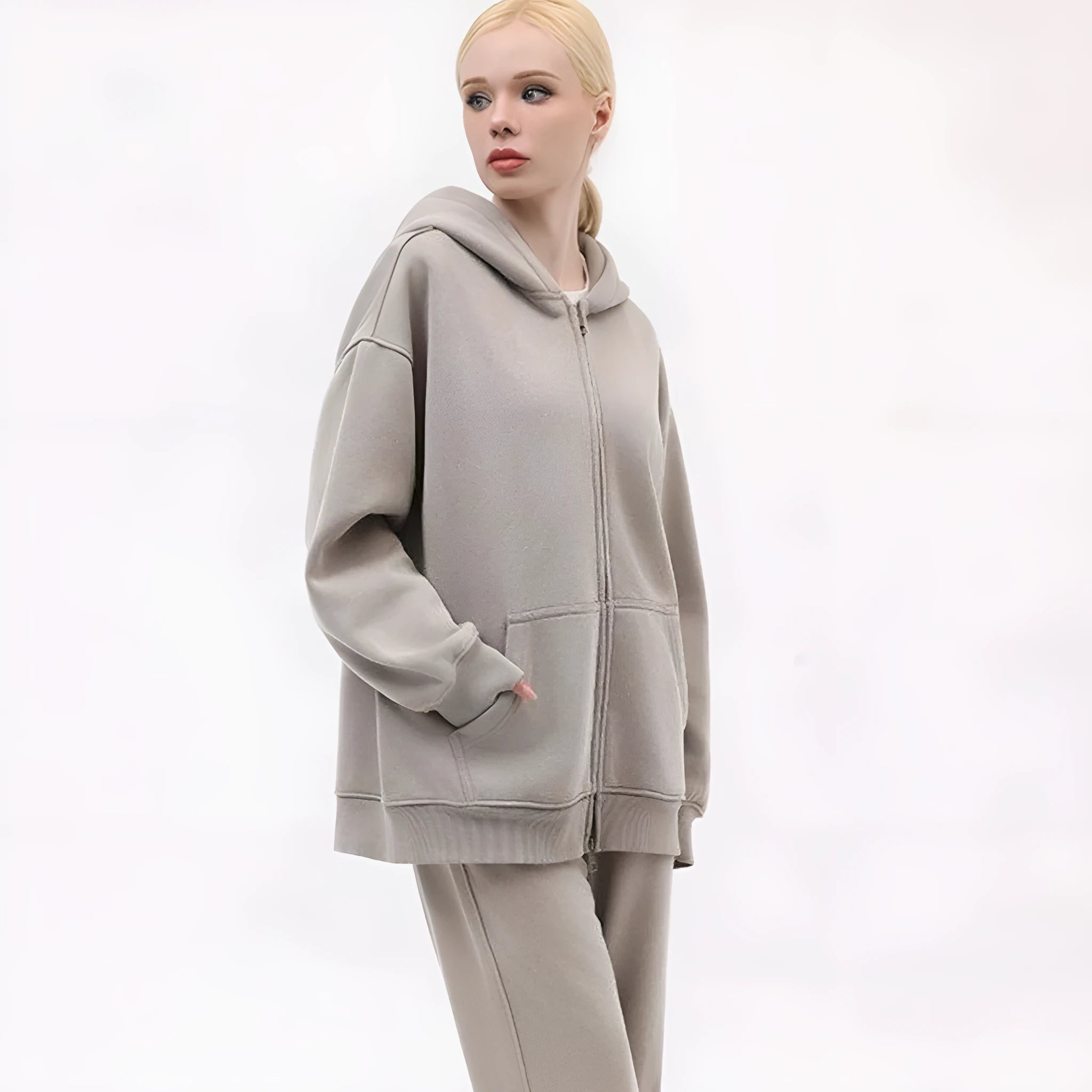 Women's loose grey fleece-lined hooded cardigan sweater with patch pockets.