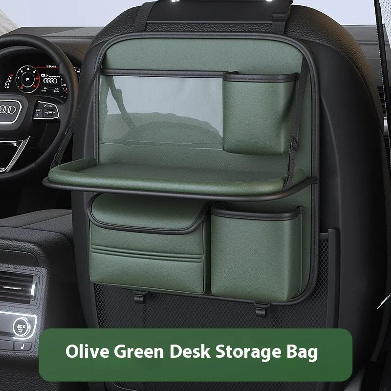 Black leather car seat storage bag with a foldable dining table deployed, hanging behind a car headrest