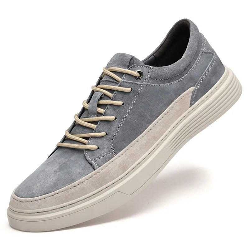 Men's grey casual skate shoes with pigskin upper and rubber sole showing lace-up front and round toe design
