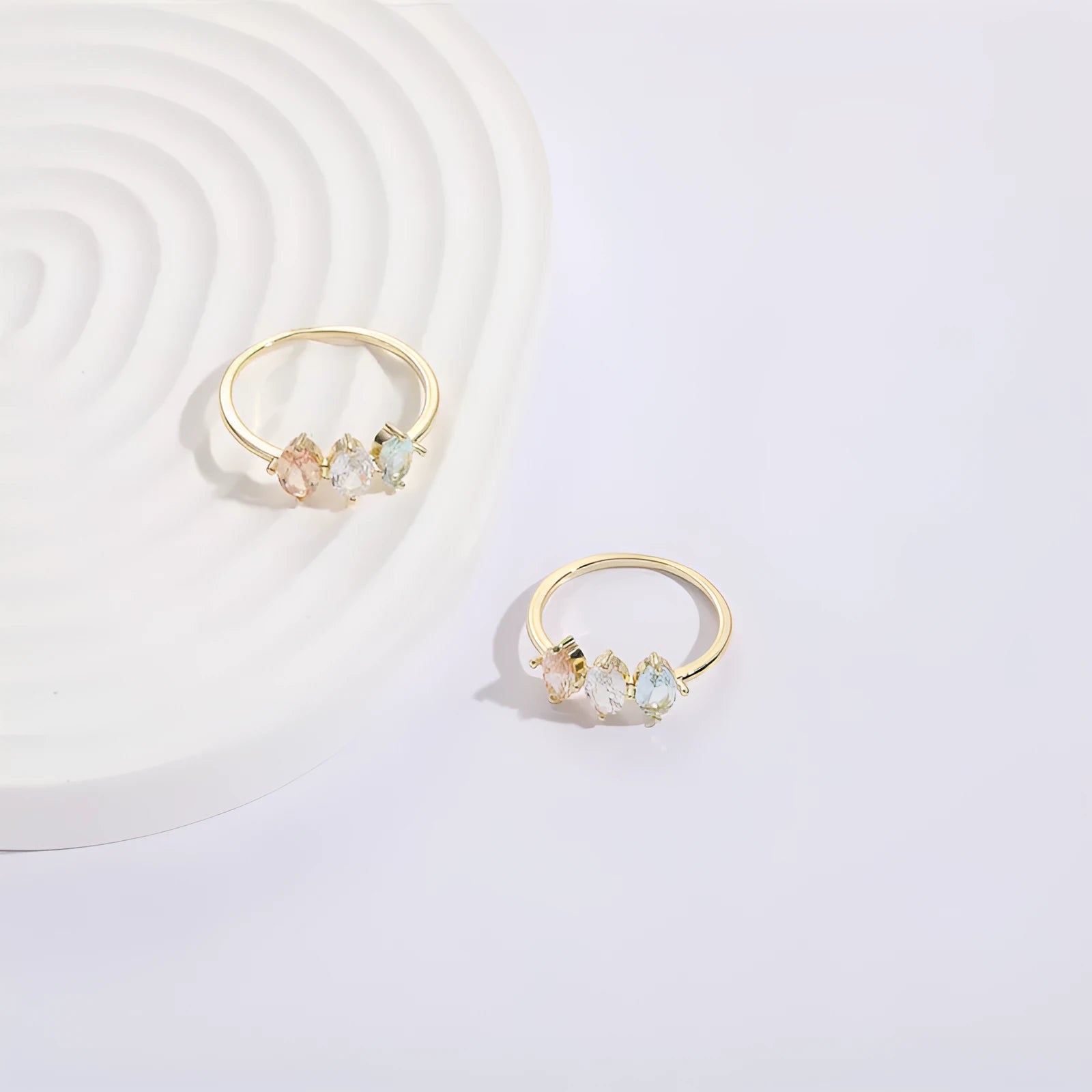 Geometric horse eye ring with tricolour zircon stones on a 14k gold-plated copper band.