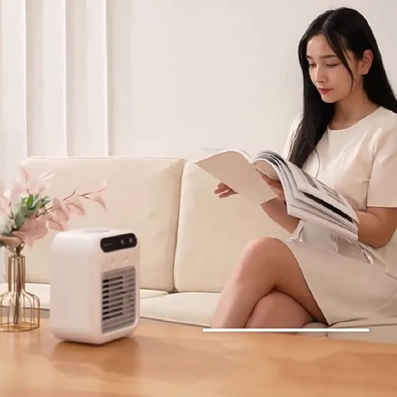 Ivory white portable USB air cooler with water tank and touchscreen controls on desk