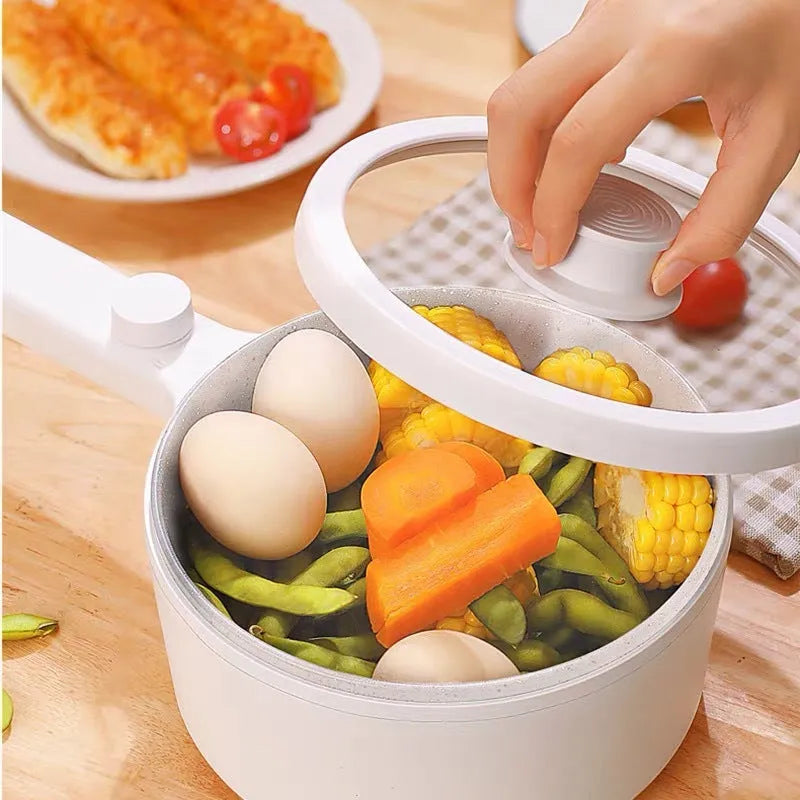 White or green portable electric hot pot cooker with multi-function controls on a countertop.