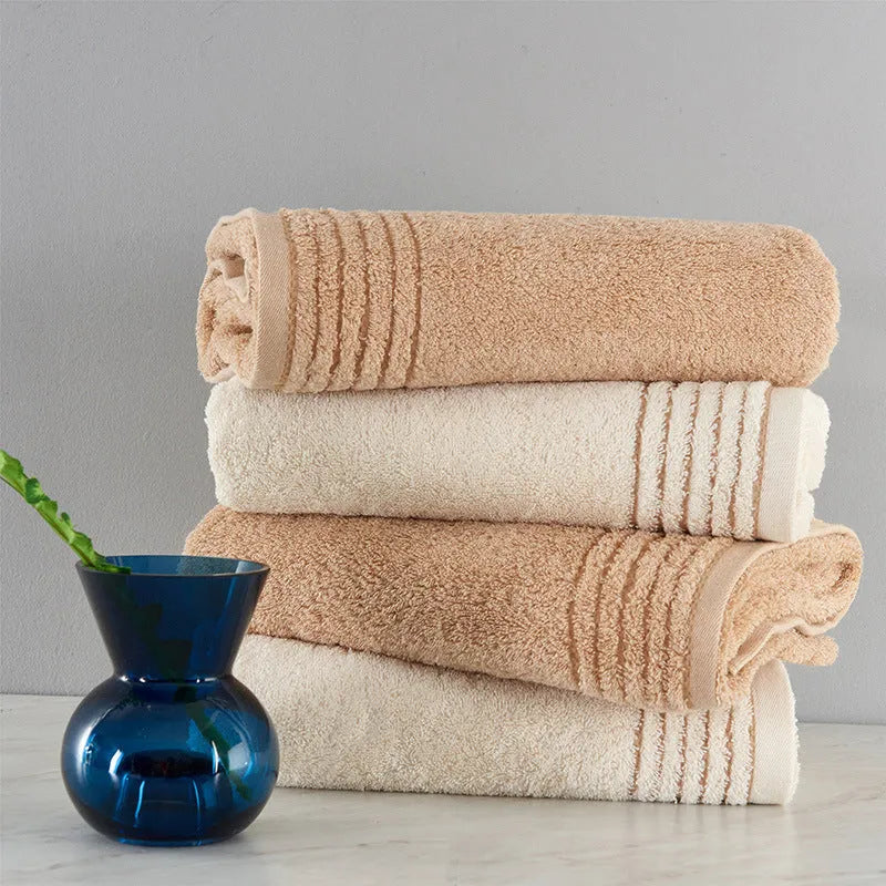 Cotton towel set in brown showing three sizes: large bath sheet, standard bath towel and small hand towel