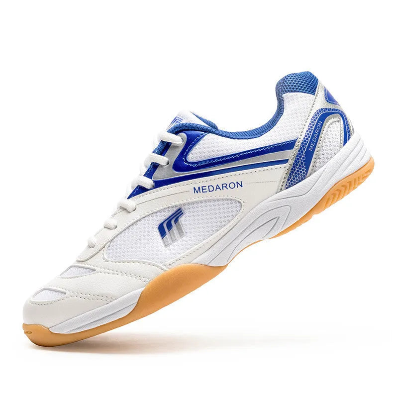 White and red table tennis sneakers with synthetic leather upper and lace-up front.