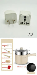 White and green mini electric hot pot cooker with stainless steel body and cooking accessories on a kitchen counter.