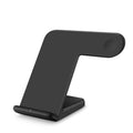 Black wireless phone charger with silicone surface measuring 140mm long on wooden desk