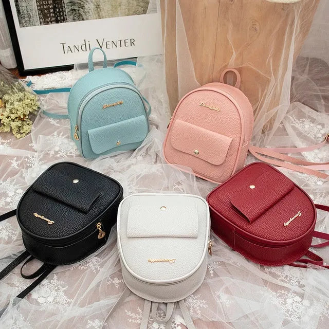 Women's small black backpack purse with adjustable straps showing 18.5cm length and zipper closure