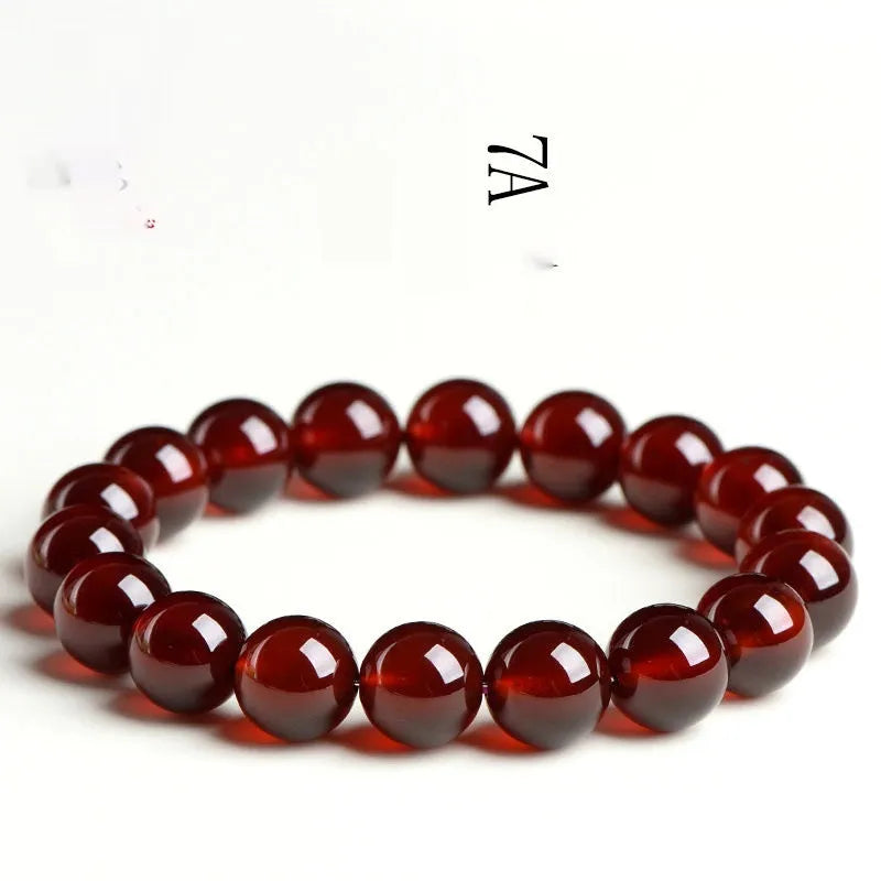 Natural orange red garnet crystal ball bracelet with retro Ruyi design on wrist