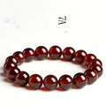 Natural orange red garnet crystal ball bracelet with retro Ruyi design on wrist