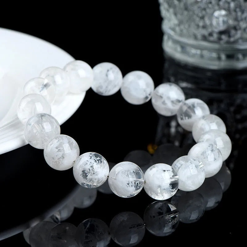 Women's crystal bracelet with round geometric beads in blizzard colour, showing Ruyi and Xiangyun design motifs.