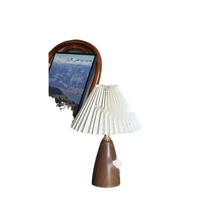 Nordic retro ceramic bedside table lamp with a pleated tapered floral fabric shade on a ceramic base.