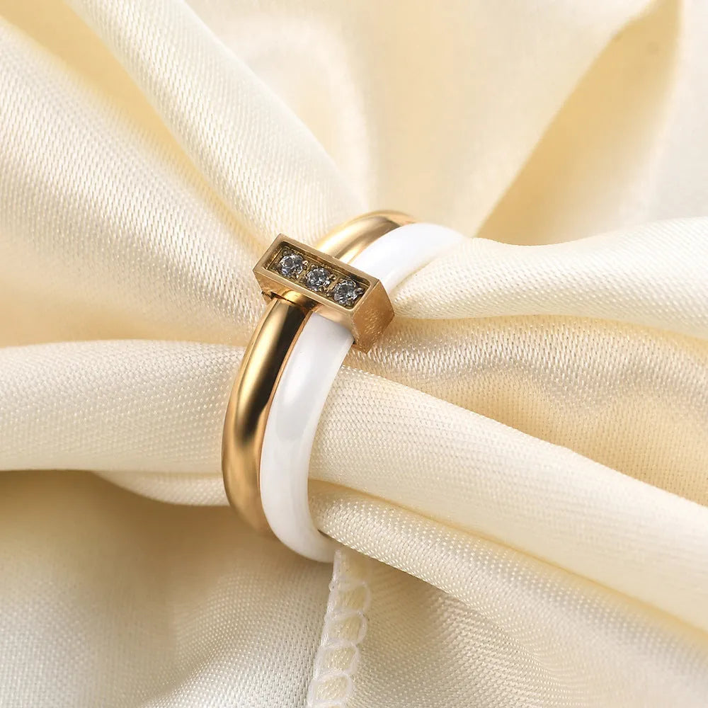 Geometric ceramic ring with zirconium inlay, available in steel black or gold white, sizes 6 to 10