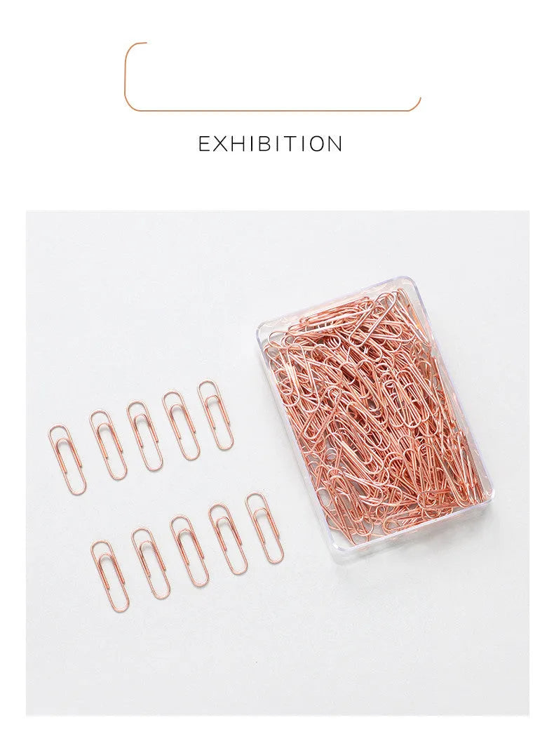 Rose gold coloured heart-shaped metal paper clips, 28mm size, in a box of 100 pieces.