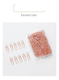 Rose gold coloured heart-shaped metal paper clips, 28mm size, in a box of 100 pieces.