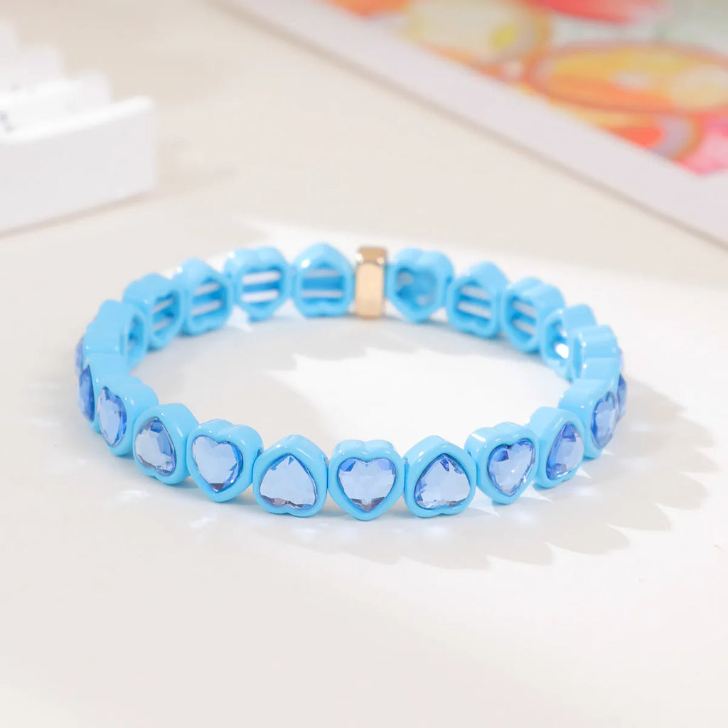 Colourful enamel heart charm on a stretch alloy bracelet.