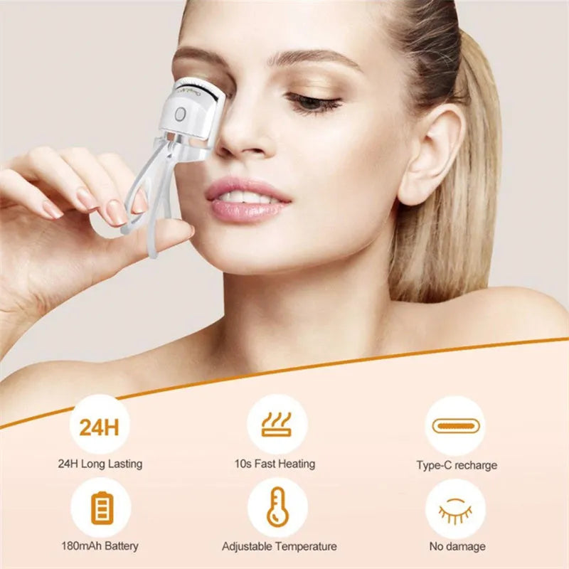 Pink and white USB rechargeable heated eyelash curler with temperature control buttons.