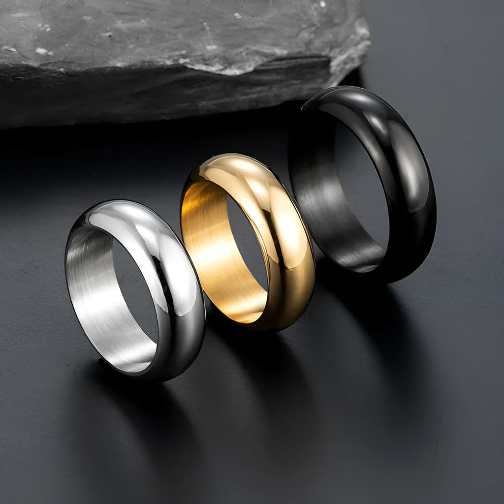 Glossy electroplated titanium steel ring in gold, black, and steel colour options on a grey background