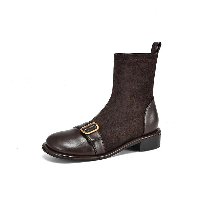 Women's black low heel Martin boots with lace-up front and belt buckle detail.