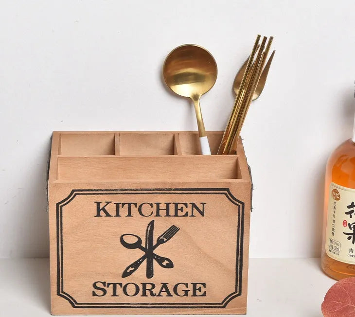 Wooden kitchen storage box with internal grid divider for organising knives, forks, and chopsticks.