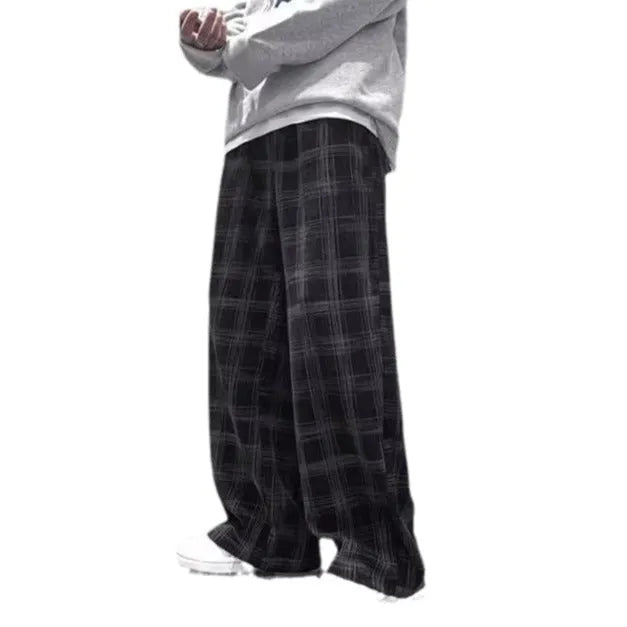 Men's black and green plaid trousers with straight leg design and mid-rise waistband