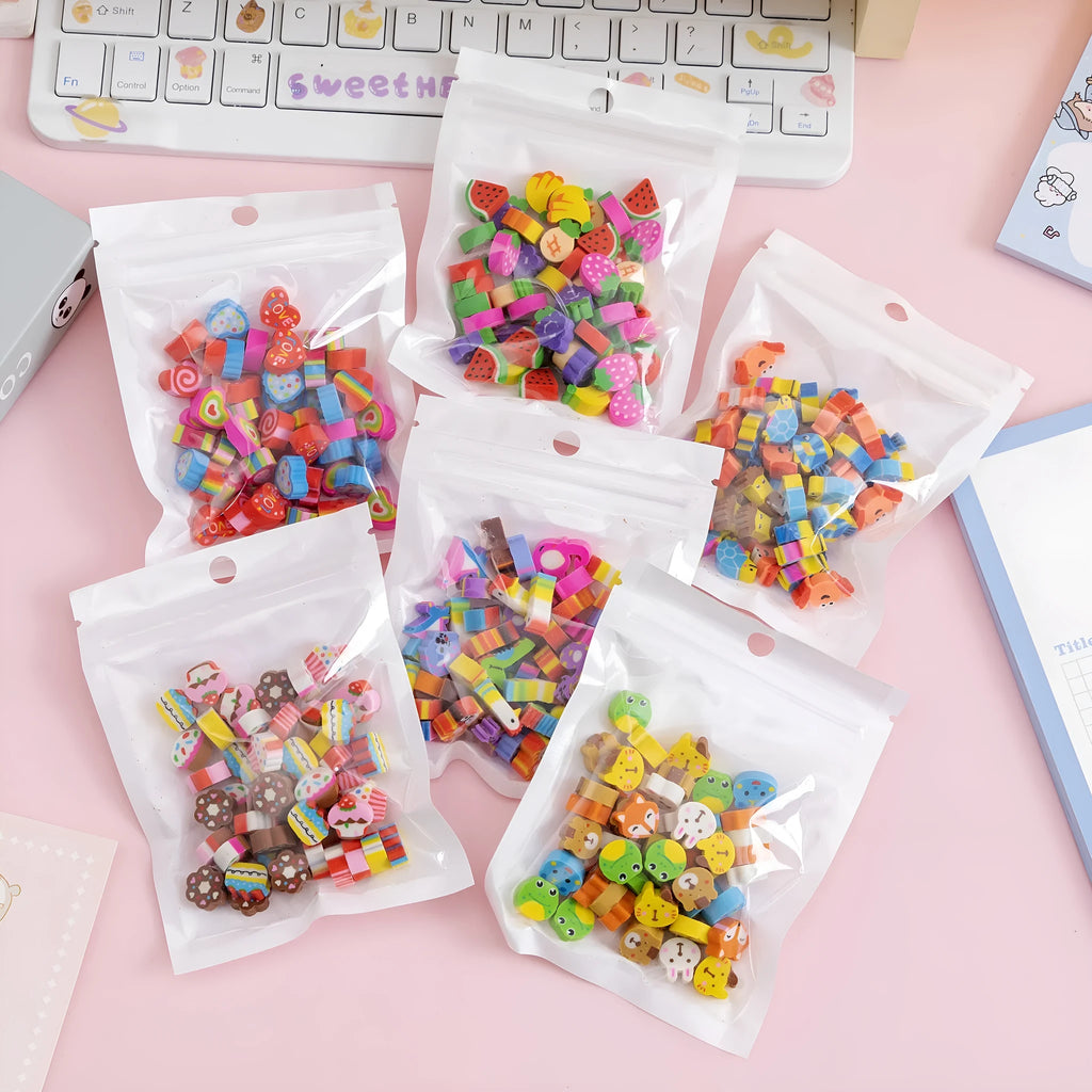 Open pearlescent film bag showing 50 small colourful cartoon fruit and theme erasers, each measuring 1-1.5 cm.